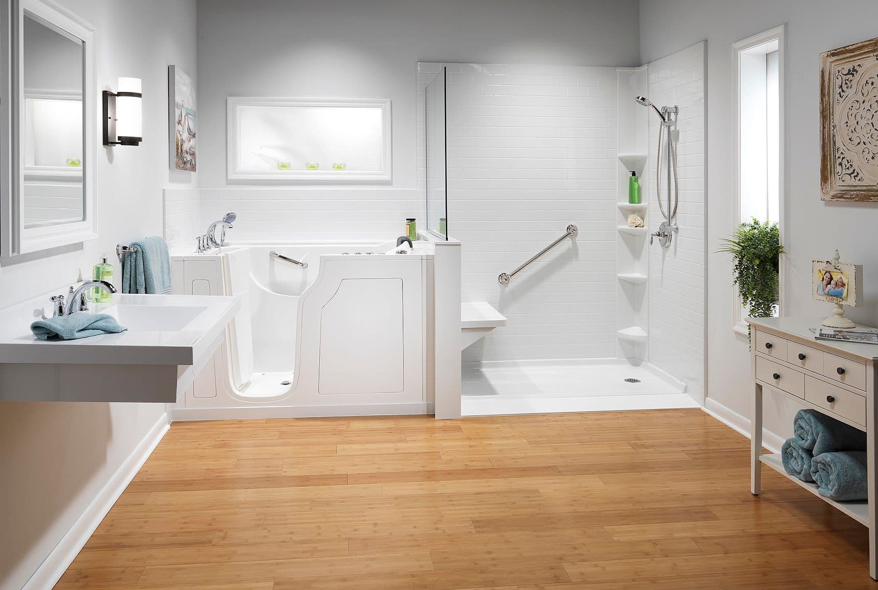 Bright, modern bathroom with a white walk-in tub and shower. Wooden floor, sleek fixtures, and gentle lighting convey a serene, accessible space.