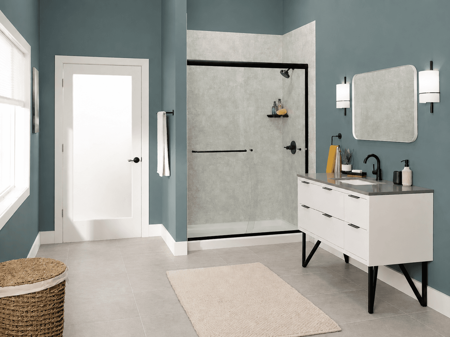 Modern bathroom with teal walls, featuring a sleek glass shower, white vanity with black faucet, rectangular mirror, towel rack, and wicker basket. Peaceful ambiance.